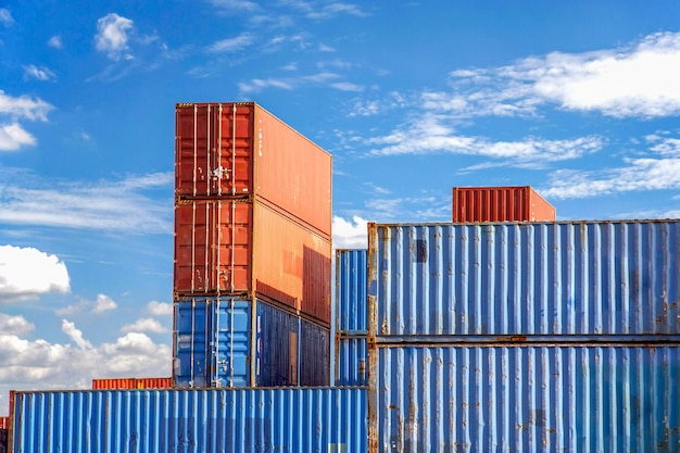 Stack of Cargo Containers in an intermodal yard with blue sky