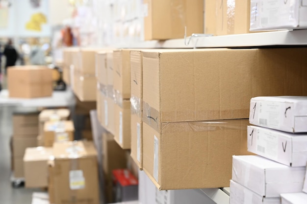 Stack of carton boxes at logistics warehouse rows of shelves\
with boxes warehouse concept