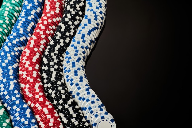 Stack of casino gambling chips isolated on black reflective background