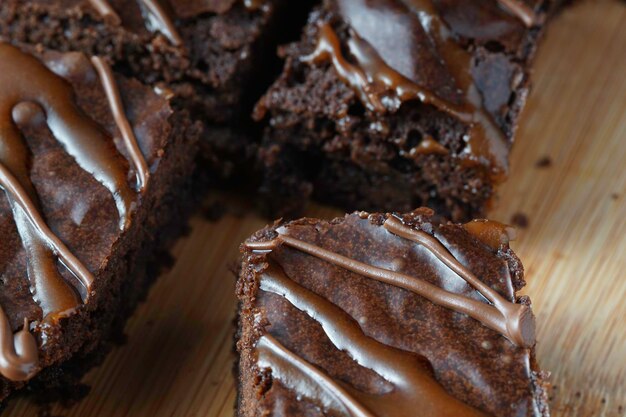 Photo a stack of chocolate brownies on a wooden background home made bakery and dessert