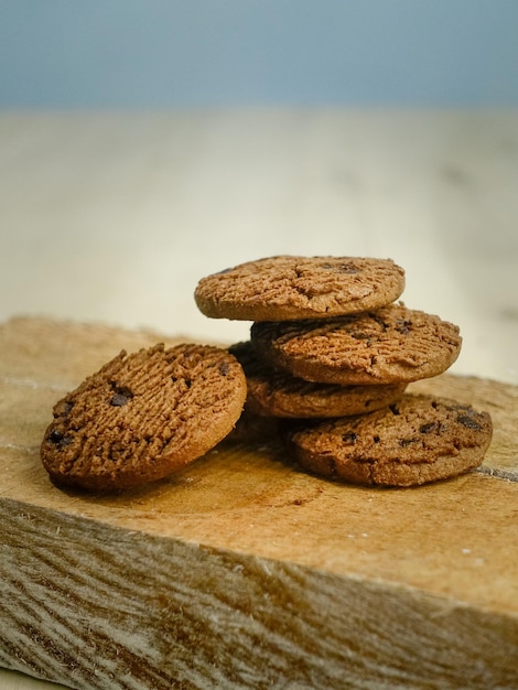 A stack of chocolate cookies on a wooden board