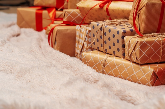 Stack of christmas gifts on beige carpet