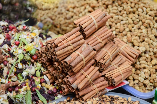 Stack of cinnamon sticks on the spice market in Istanbul, Turkey. Local traditional trading centers in Asia offer fresh ingredient for cooking tasty food.