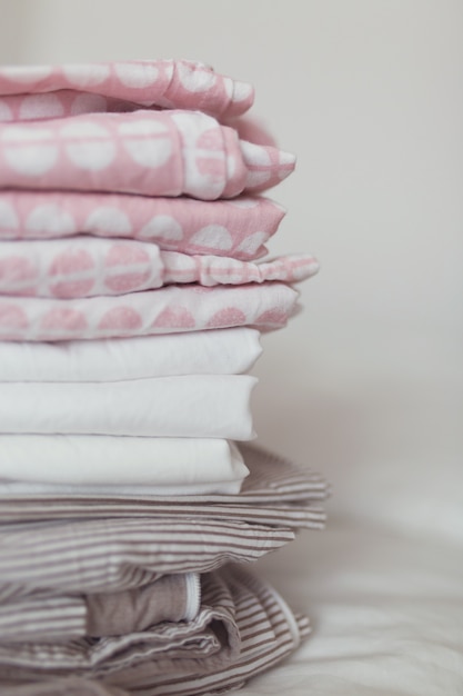 A stack of clean and ironed linen is on the bed