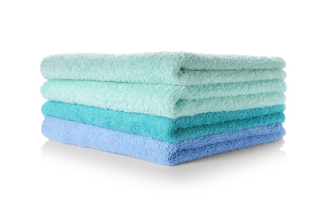 Stack of clean soft towels on white background