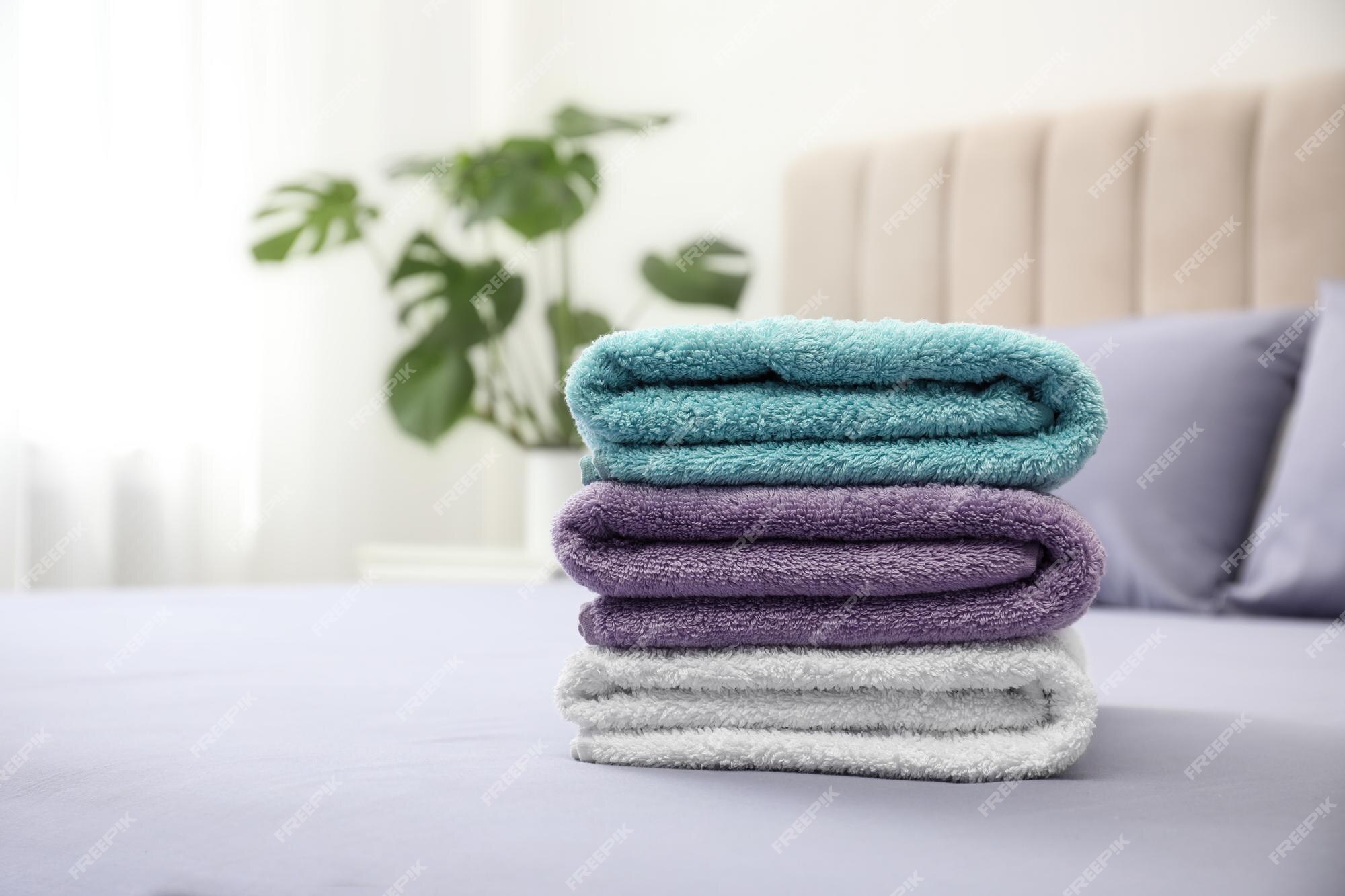 Premium Photo  Stack of clean towels on bed indoors space for text