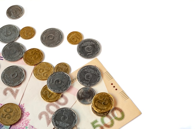 Stack of coins and banknotes on a white background Place for text