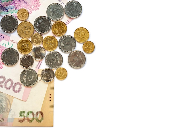 Stack of coins and banknotes on a white background Place for text