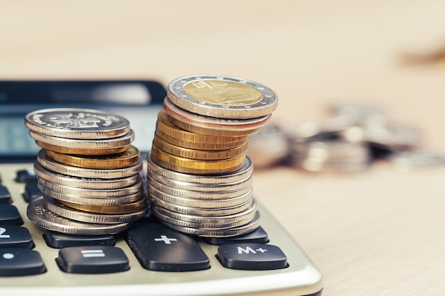 Stack of coins and calculator,concept idea for business finance