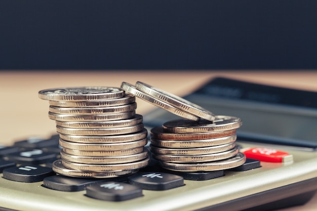 Stack of coins and calculator