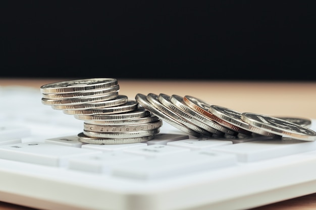 Photo stack of coins and calculator