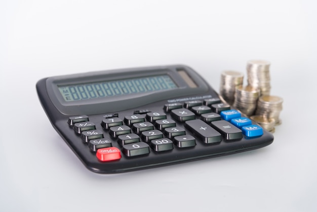 Stack of coins and calculator