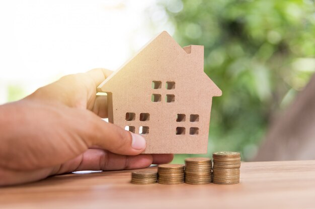 Stack coins and house wood model