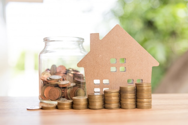 Stack coins and house wood model