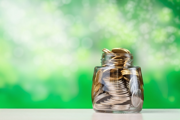 Stack of coins piled in glass jar. The concept of investment growth and finance.