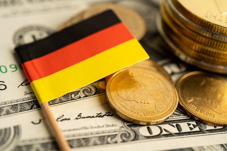 Photo stack of coins with germany flag and us dollar banknotes