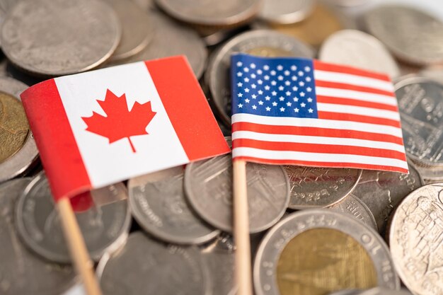 Stack of coins with USA America and Canada flag finance concept