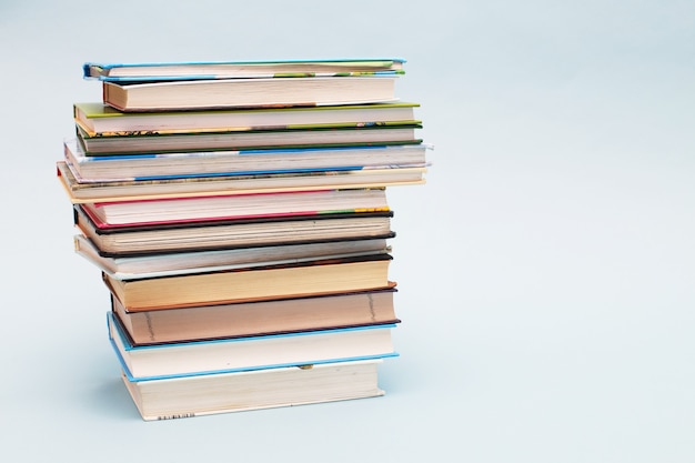 Stack of colorful books on a blue background