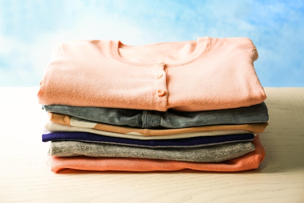 Stack of colorful clothes on light background
