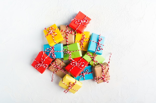 Stack of colorful gifts over white background with copy space, flat lay style