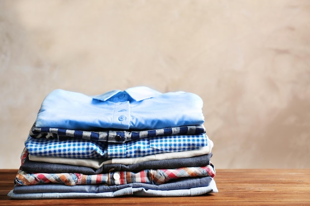 Stack of colorful shirts on table