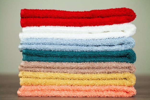 Stack colorful towels in bathroom on table