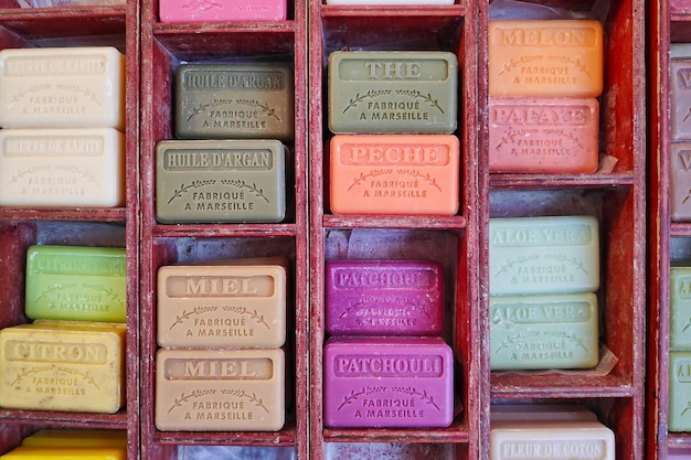 Stack of colorfull bar of soaps made in marseille on a market\
stall