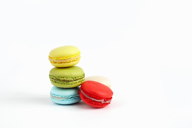 Stack of colourful macaroons or macaron isolated on white French dessert background