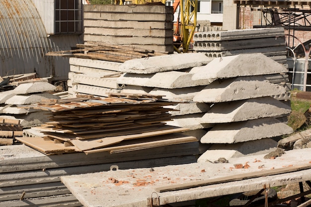 Stack of concrete slabs and metal sheets on the construction site