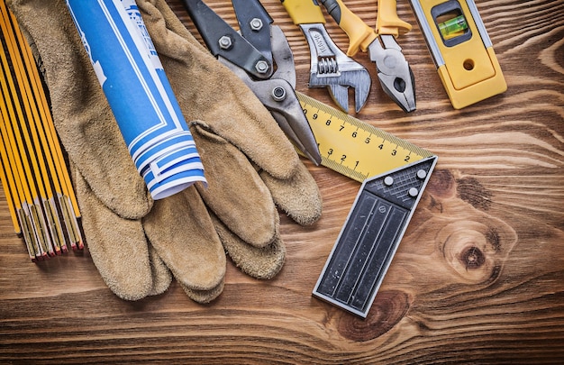 Stack of construction tools on vintage wooden board