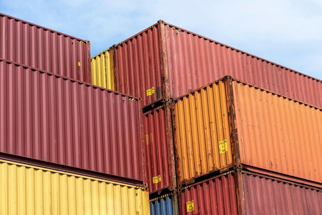 Foto una pila di container in piedi l'uno sopra l'altro nel cortile di carico vicino al molo