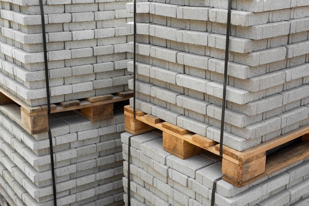 Stack of contemporary stone Paving slabs pavers Building material on pallet for road paving