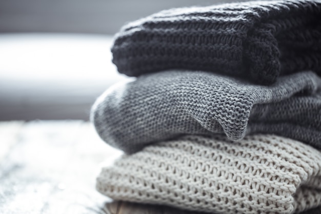 stack of cozy knitted sweaters