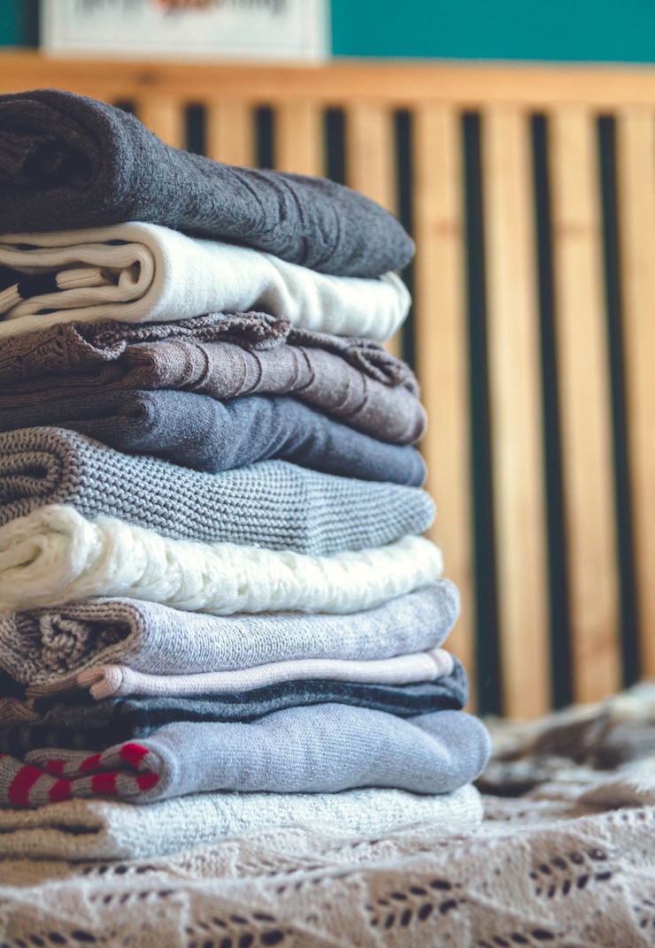 Photo a stack of cozy warm winter clothes