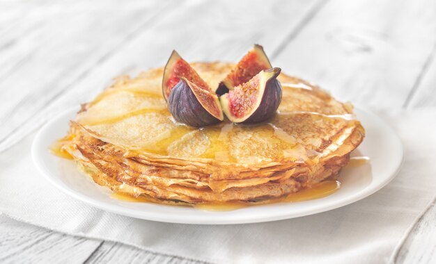 Stack of crepes on the white plate