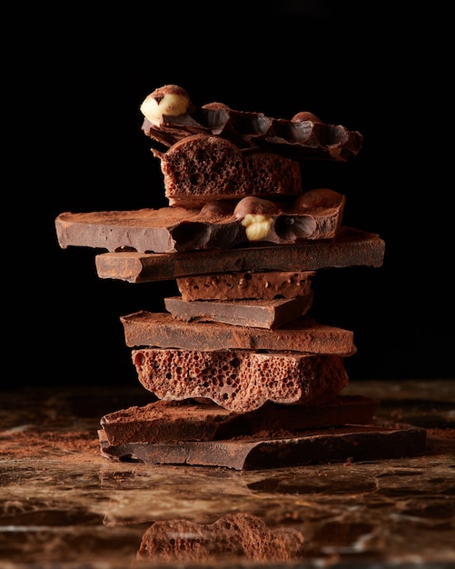 Stack dark chocolate isolated on a dark marble surface