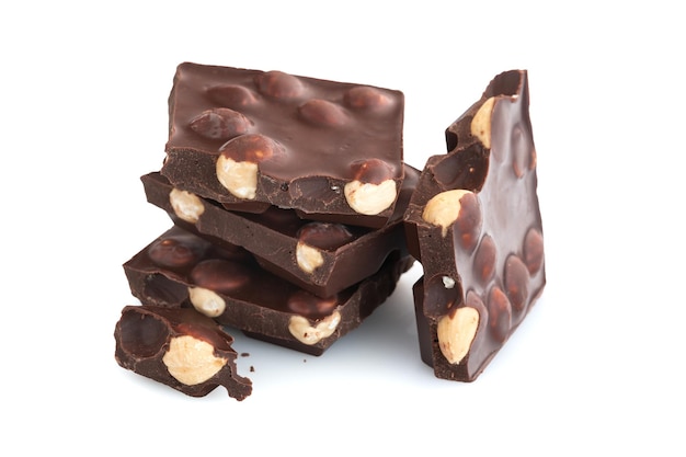 Stack of dark chocolate pieces with nuts isolated on a white background