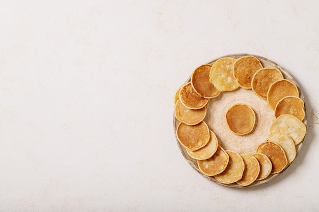 Stack of delicious mini pancakes on plate