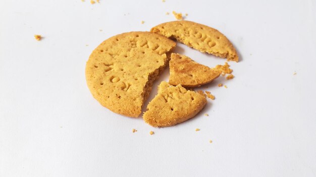 A stack of delicious wheat round biscuits with chocolate filling isolated on white background