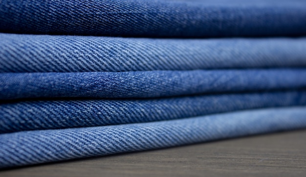 A stack of denim color denim closeup texture