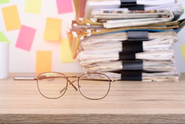 stack documents and back paper clip pace on wood desk in office.