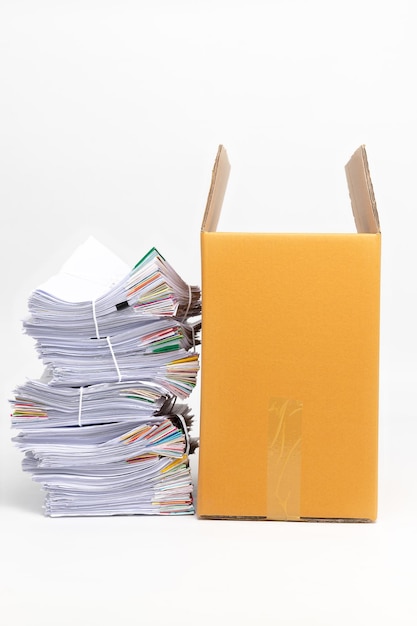 Stack of Documents and corrugated cardboard box isolated on white background