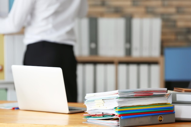 Stack of documents on office employee's table closeup