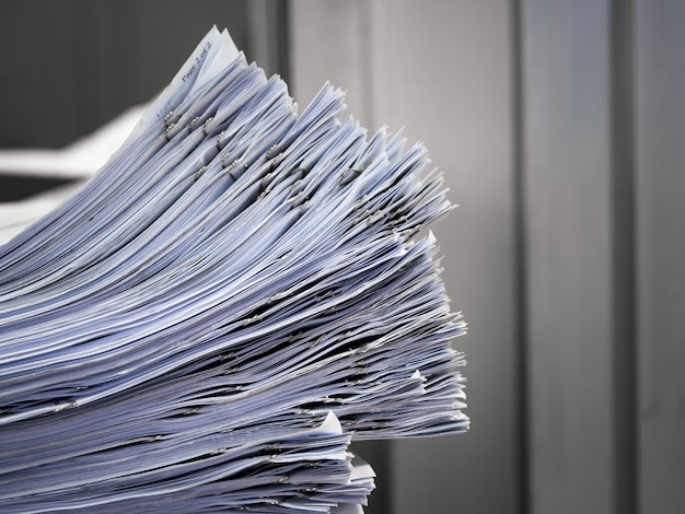 Photo the stack of documents placed on the desk.