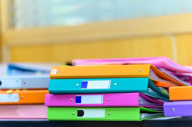 Stack of documents on wooden desk in office