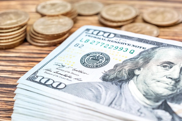 Stack of dollar bills and coins on the table