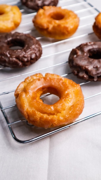 A stack of donuts on a wire rack with one that says'donuts'on it