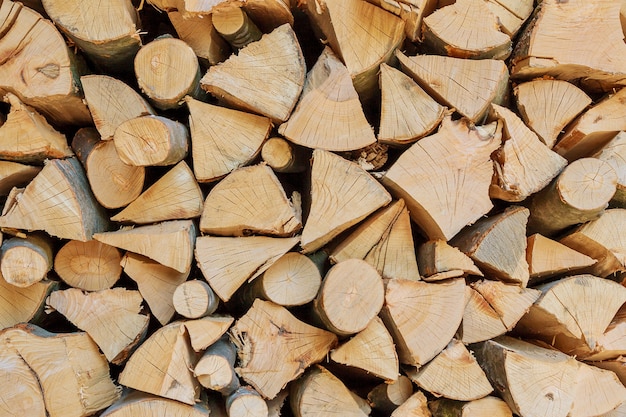 Stack of dry chopped wooden logs.