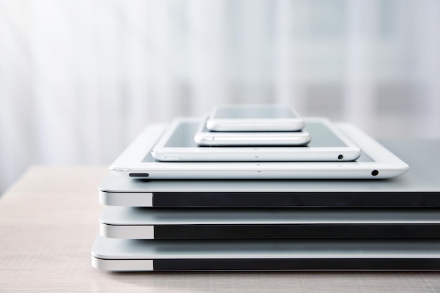 Stack of electronic device on wooden table