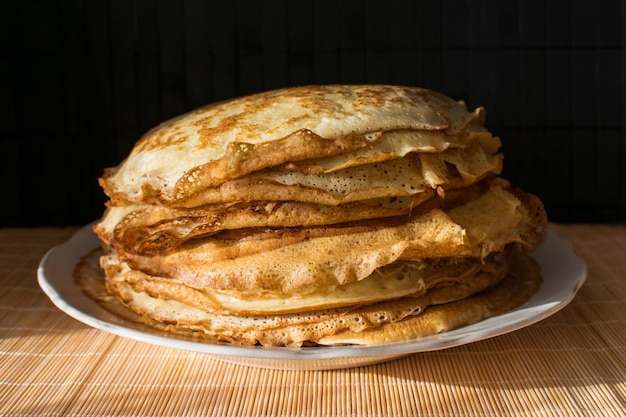 Stack of English pancakes on a round white plate